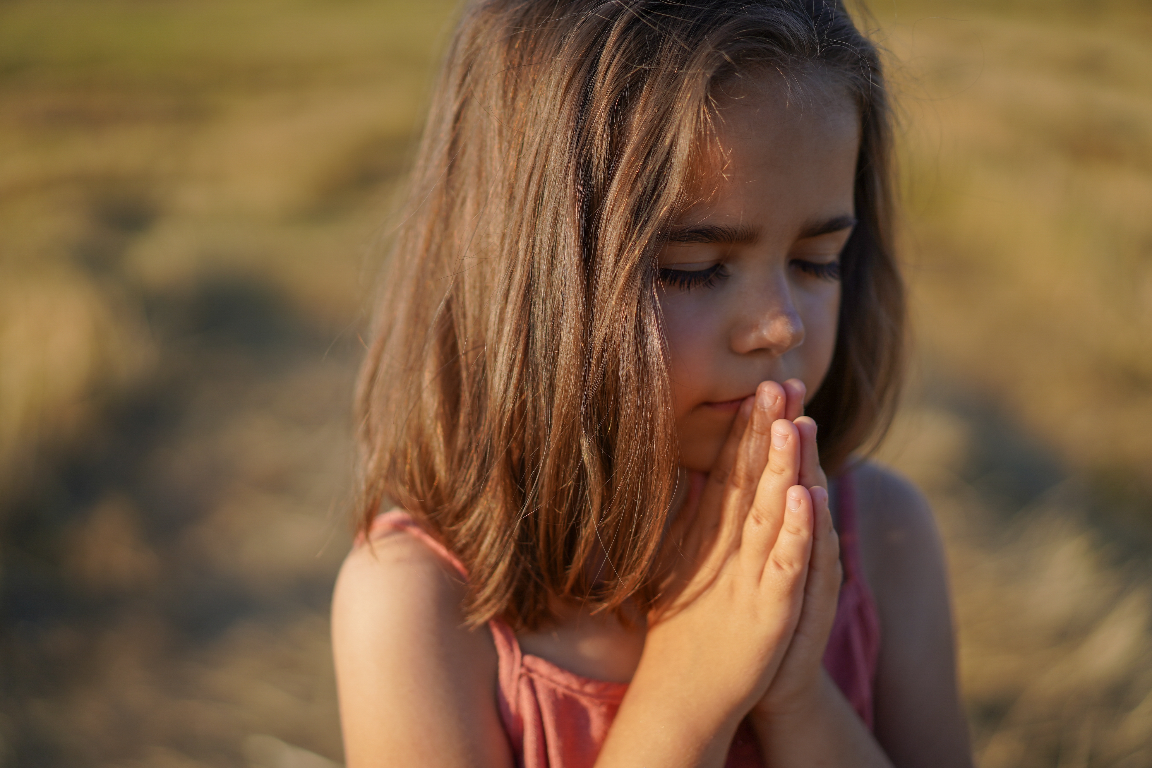 little-girl-closed-her-eyes-praying-in-a-field-h-2021-09-01-13-46-02-utc